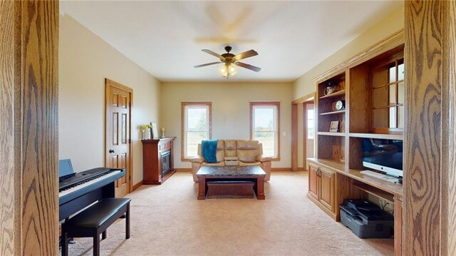 sitting room featuring light carpet and ceiling fan