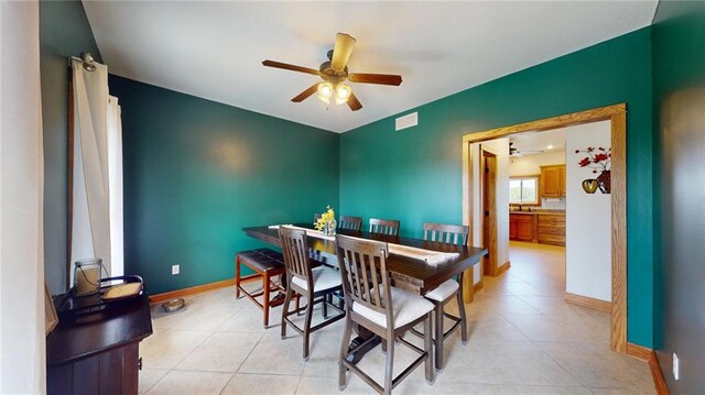 dining space with ceiling fan and light tile patterned floors