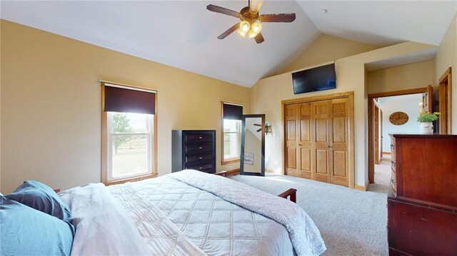 bedroom featuring a closet, lofted ceiling, ceiling fan, and carpet floors