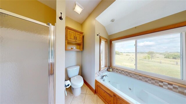 bathroom featuring shower with separate bathtub, tile patterned flooring, vaulted ceiling, and toilet