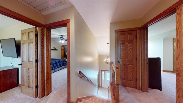 hallway with light colored carpet