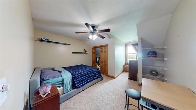 carpeted bedroom with ceiling fan and lofted ceiling