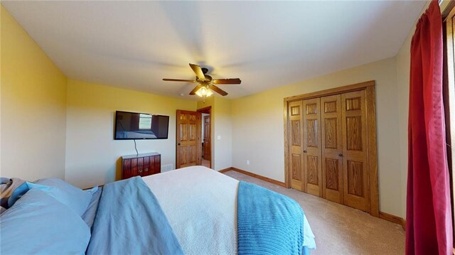 bedroom with a closet, ceiling fan, and carpet floors