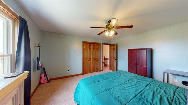 carpeted bedroom with ornamental molding and ceiling fan