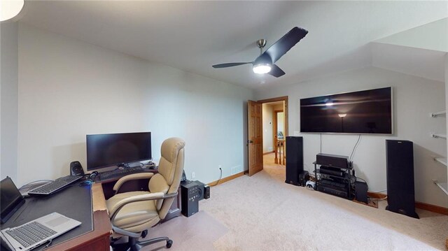 carpeted home office featuring vaulted ceiling and ceiling fan