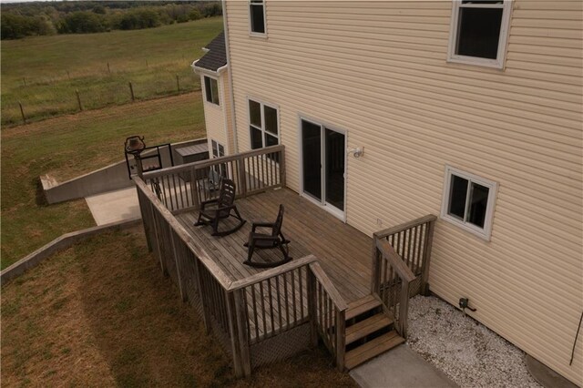 wooden deck featuring a lawn