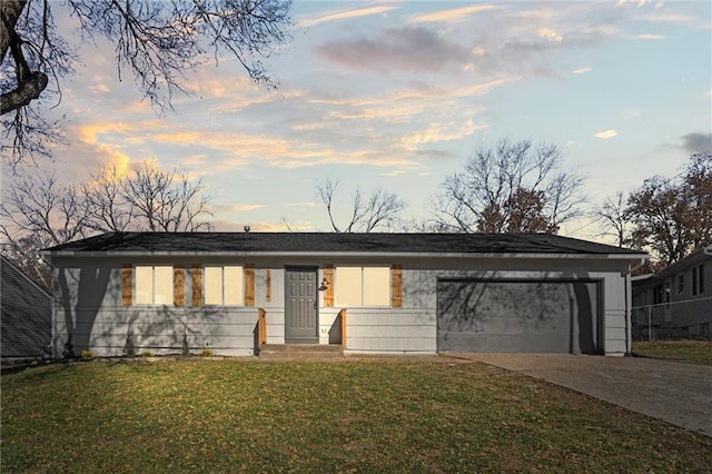 single story home featuring a yard and a garage