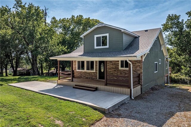 back of house with a deck and a yard