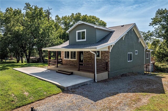 rear view of house with a lawn and a deck