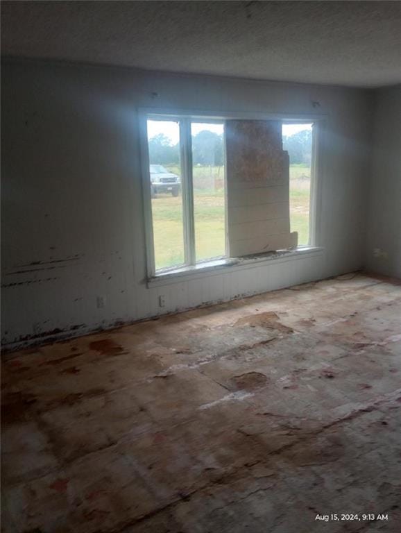 spare room with a textured ceiling