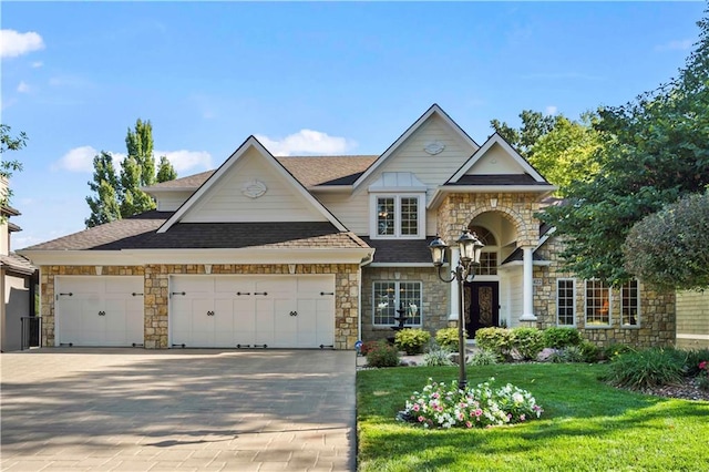 view of front of property featuring a garage and a front yard