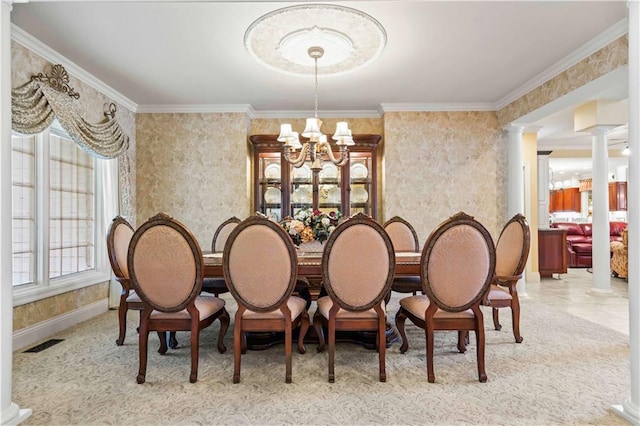 dining area with ornamental molding, plenty of natural light, ornate columns, and a chandelier