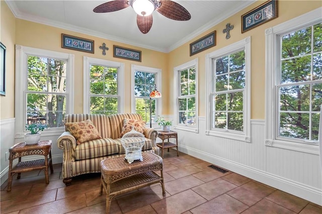 sunroom / solarium featuring ceiling fan