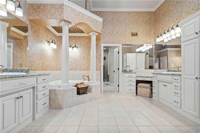 bathroom featuring vanity, tiled bath, decorative columns, tile patterned flooring, and ornamental molding