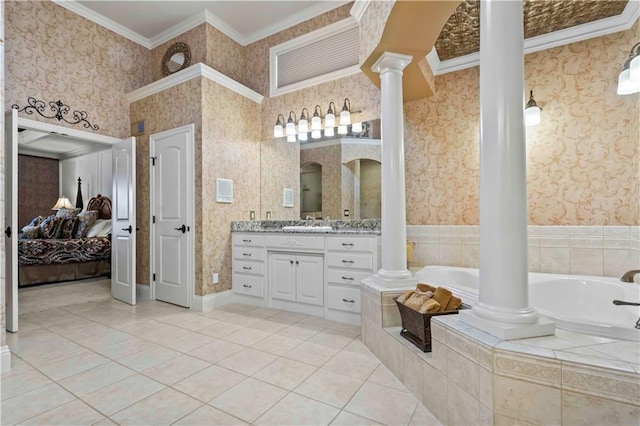 bathroom featuring tile patterned floors, ornate columns, ornamental molding, tiled bath, and vanity