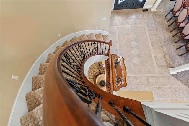 stairs featuring tile walls