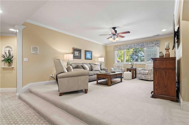 living room featuring ceiling fan, light colored carpet, crown molding, and ornate columns