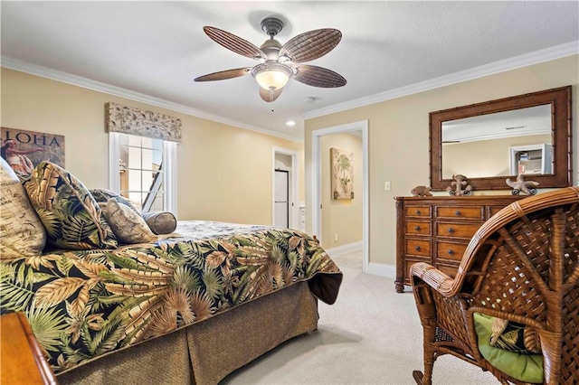 bedroom featuring ceiling fan, light colored carpet, connected bathroom, and crown molding