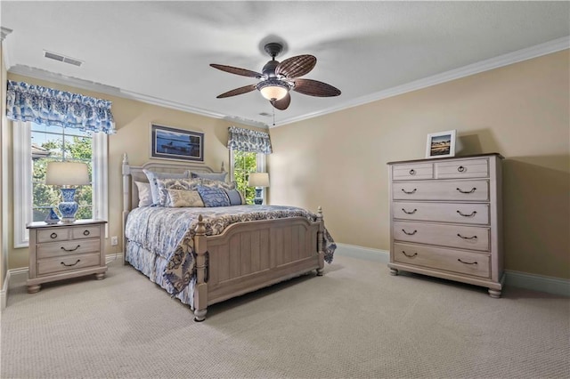 bedroom featuring crown molding, ceiling fan, and light carpet