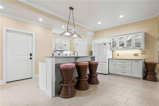 kitchen featuring crown molding, pendant lighting, white appliances, and white cabinets