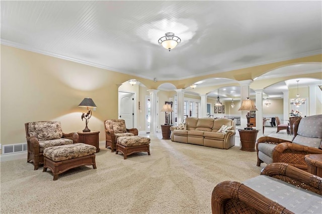 living room featuring ornamental molding, light carpet, and ornate columns