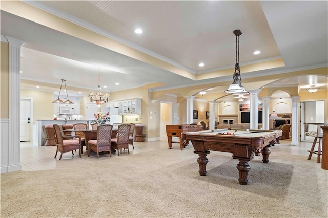 recreation room with ornamental molding, pool table, a tray ceiling, ornate columns, and light colored carpet