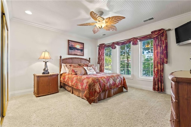 carpeted bedroom with ceiling fan and crown molding