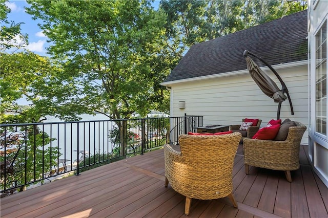 wooden terrace with an outdoor living space