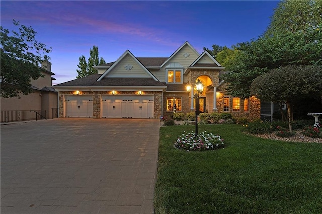 craftsman-style house with a lawn and a garage