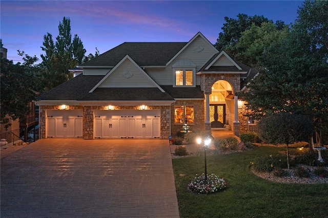 view of front of home featuring a lawn and a garage