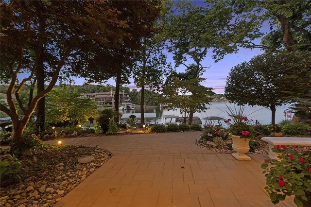 view of home's community with a patio and a water view