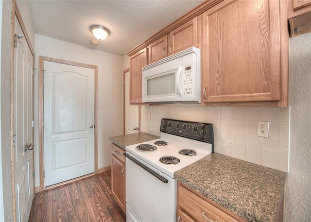 kitchen with white appliances, dark stone counters, dark wood-type flooring, tasteful backsplash, and a textured ceiling