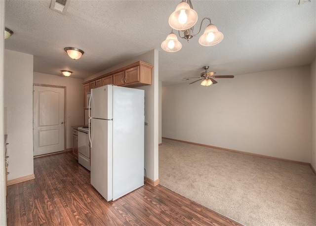 kitchen featuring a textured ceiling, white appliances, dark hardwood / wood-style flooring, light brown cabinets, and ceiling fan