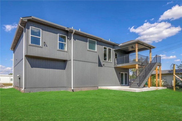 back of house featuring a patio area, a deck, and a lawn