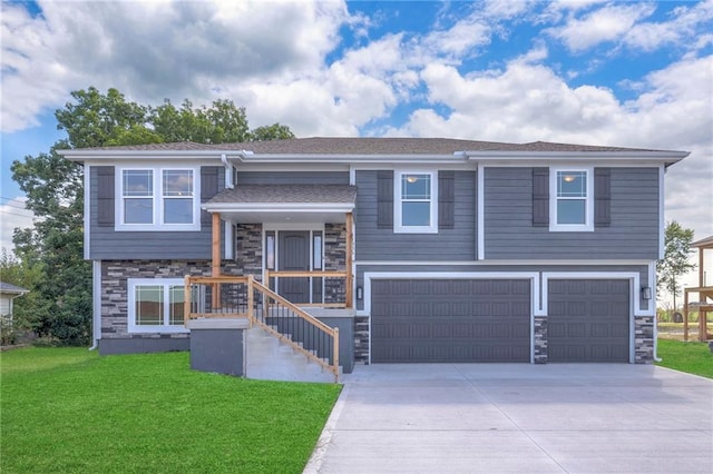 split foyer home featuring covered porch, a front lawn, and a garage