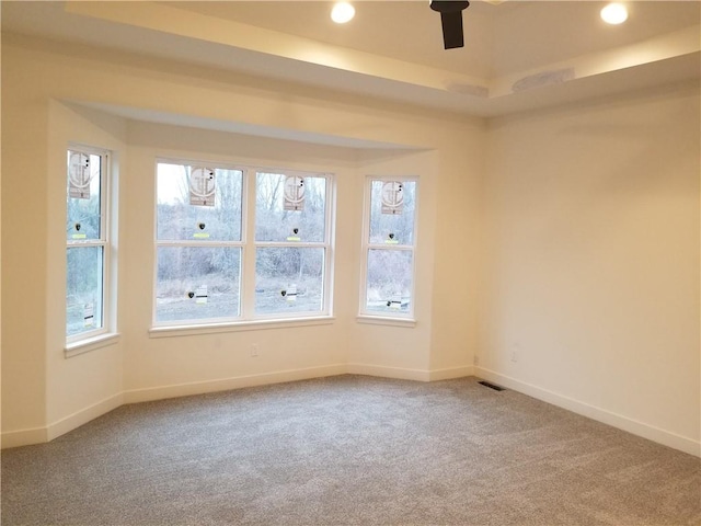 carpeted spare room featuring recessed lighting, visible vents, and baseboards