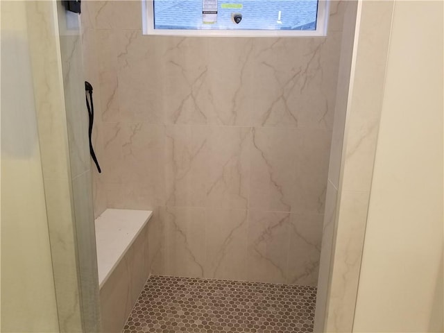 bathroom featuring a marble finish shower