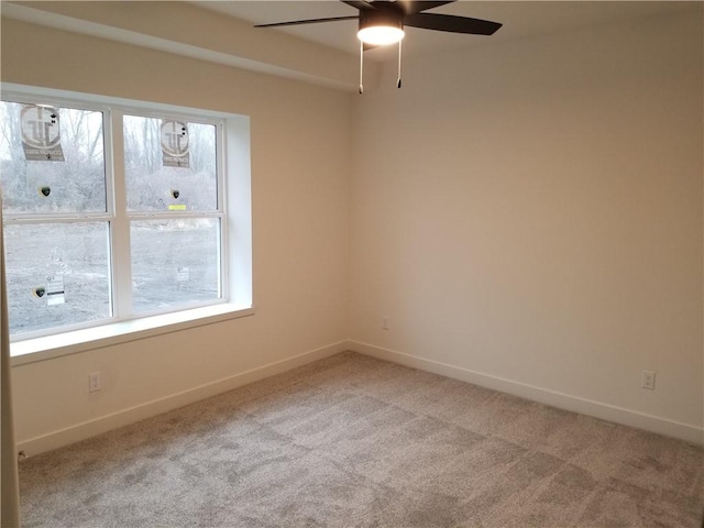 carpeted empty room featuring ceiling fan