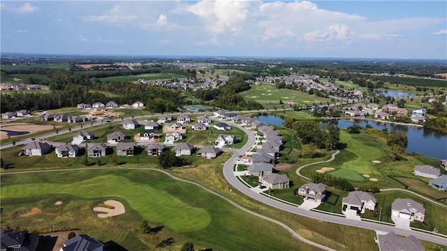 bird's eye view featuring golf course view, a water view, and a residential view