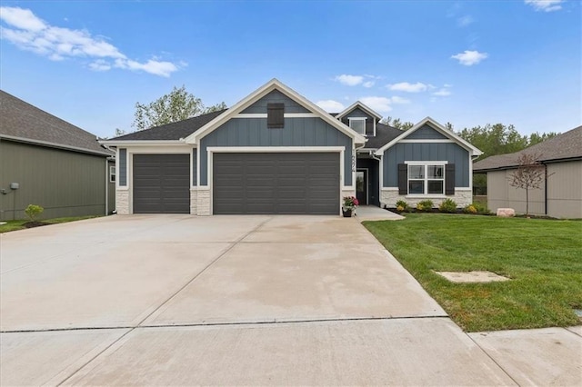 14574 Aurora Ln, Basehor, KS 66007 - craftsman-style house featuring board and batten siding, a front lawn, driveway, stone siding, and a garage