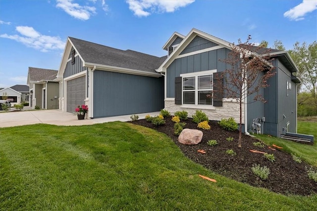 14574 Aurora Ln, Basehor, KS 66007 - view of front of house featuring an attached garage, driveway, a front lawn, and board and batten siding