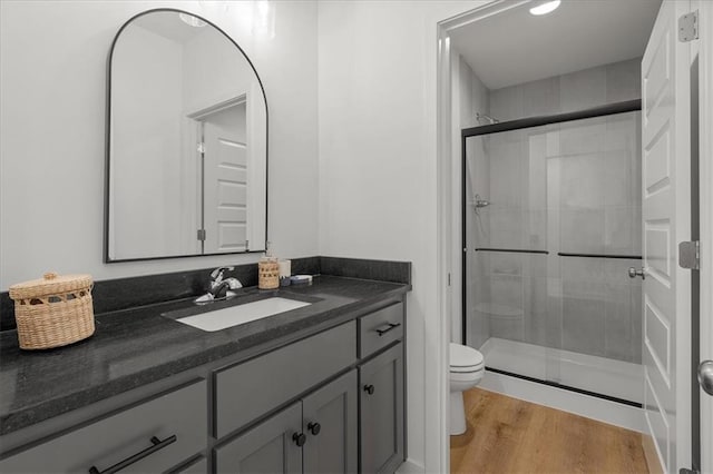 14574 Aurora Ln, Basehor, KS 66007 - bathroom featuring toilet, a shower stall, vanity, and wood finished floors