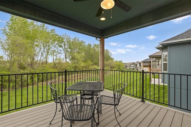 14574 Aurora Ln, Basehor, KS 66007 - deck with a ceiling fan, outdoor dining area, a lawn, and a residential view