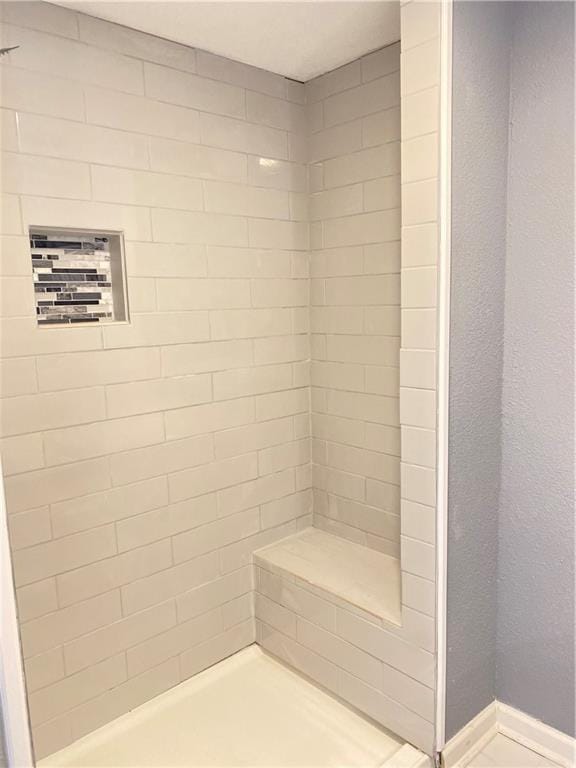 bathroom with tiled shower