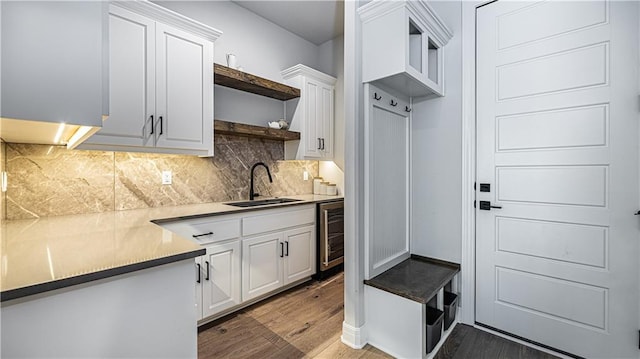 mudroom with dark hardwood / wood-style floors, wine cooler, and sink