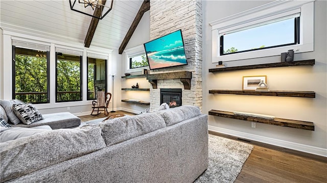 living room with beamed ceiling, wooden ceiling, a fireplace, wood-type flooring, and high vaulted ceiling