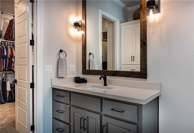 bathroom featuring ornamental molding and vanity