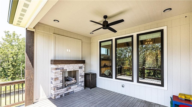 exterior space featuring ceiling fan and a fireplace