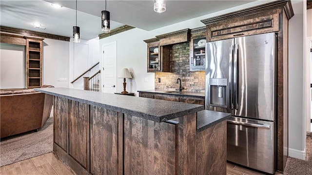 kitchen featuring dark brown cabinets, light hardwood / wood-style flooring, sink, hanging light fixtures, and stainless steel refrigerator with ice dispenser