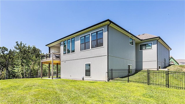 view of side of property featuring a balcony and a lawn